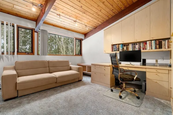 a livingroom with workspace and a window