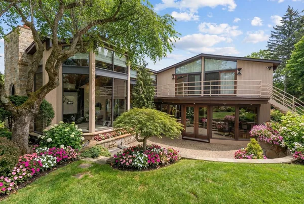 a front view of a house with a garden
