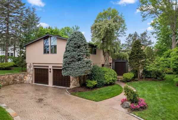 a front view of a house with a garden