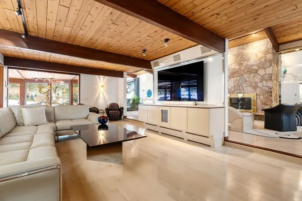 a living room with furniture a flat screen tv and a fireplace