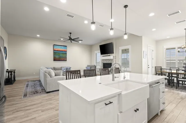 a view of a dining room with furniture a chandelier and wooden floor