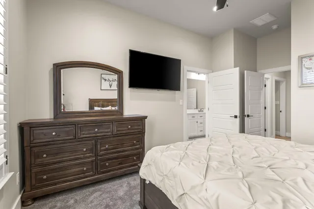a bathroom with a double vanity sink toilet mirror and bathtub