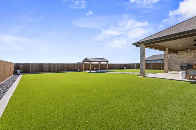 a big house with a big yard and large trees
