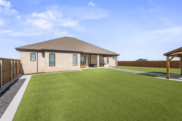 a view of a swimming pool and a yard