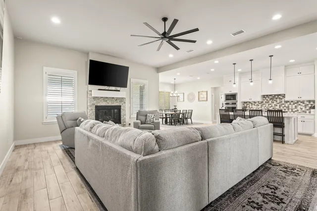 a living room with furniture fireplace and a flat screen tv