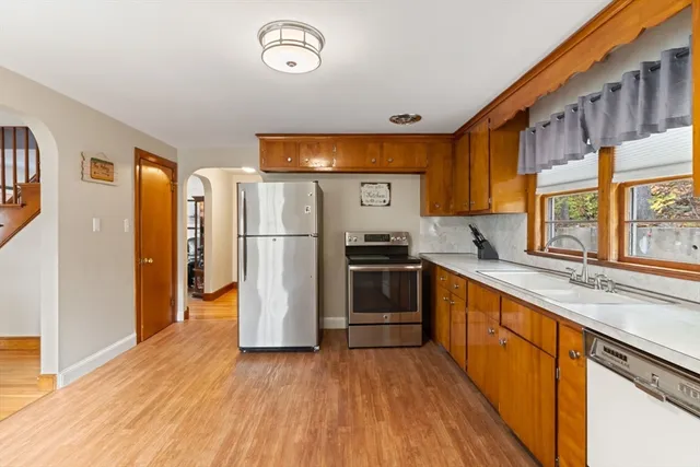 a kitchen with stainless steel appliances a refrigerator and a stove top oven