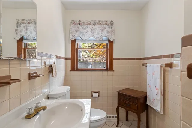 a bathroom with a toilet sink and shower