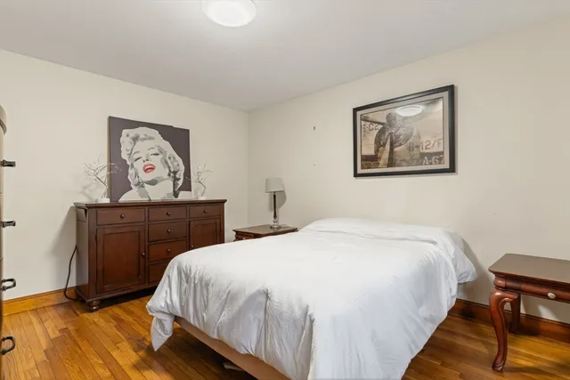 a bedroom with a bed and a painting on the wall