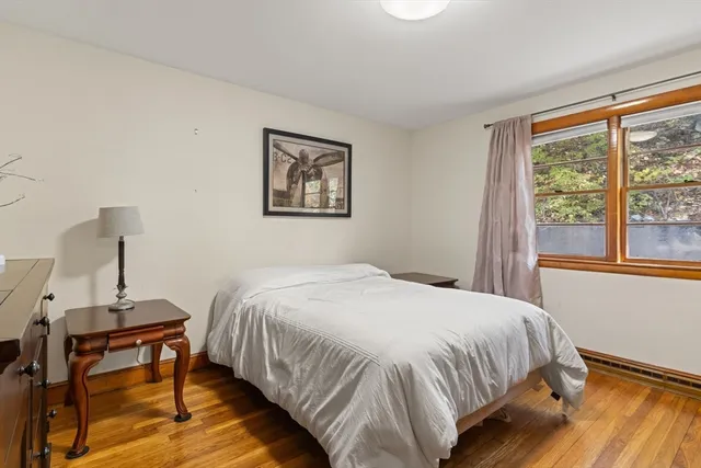 a bedroom with a bed a table and a window