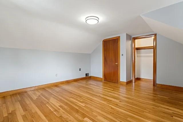 a view of an empty room and wooden floor