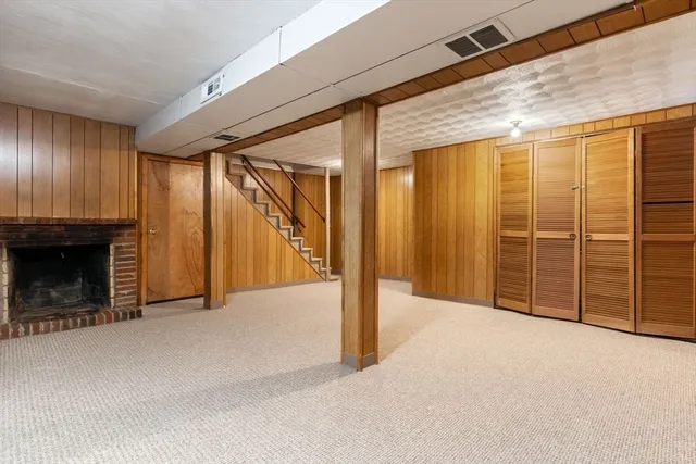 a view of an empty room with a fireplace