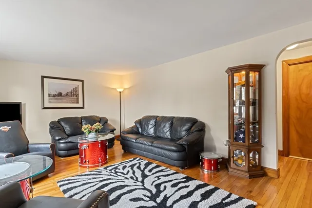 a living room with furniture ceiling fan and a window