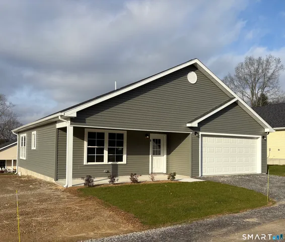 a front view of a house with a garden