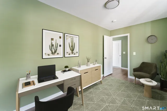 a view of a room with wooden floor and fan