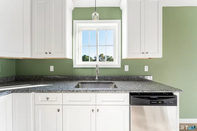a kitchen with a sink and a refrigerator