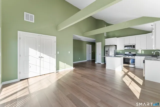 a bedroom with a large bed and a window