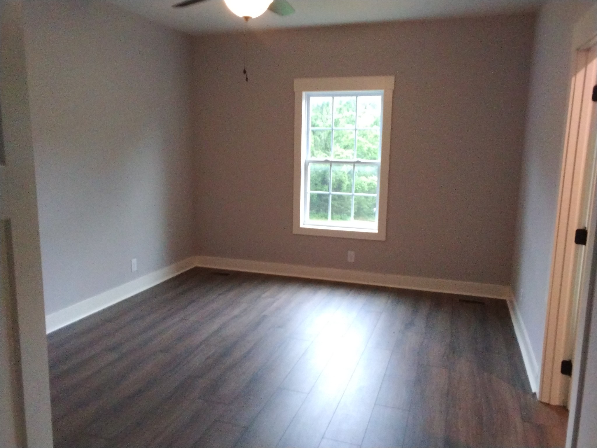 2006 McMahan Hollow Road Pleasant View, TN 37146 - Photo 11 of 20 an empty room with wooden floor and windows