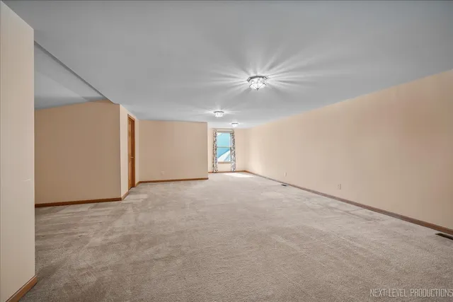 a view of an empty room with a ceiling fan