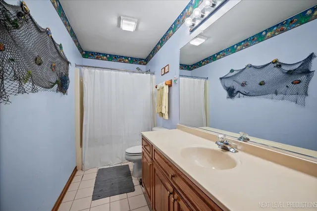 a bathroom with a sink and mirror with toilet