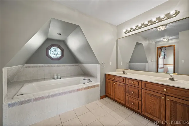 a spacious bathroom with a double vanity sink and a mirror