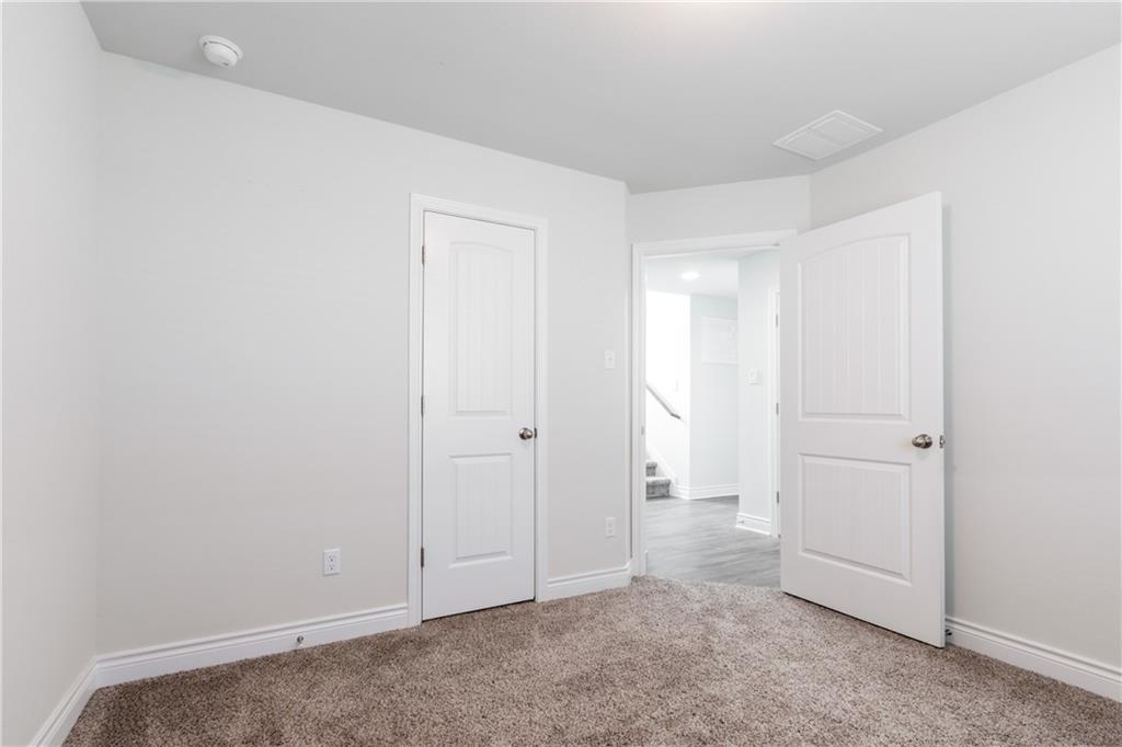 2104 Pindos Pony Way Georgetown, TX 78626 - Photo 21 of 30 An inviting room awaits personalization with plush carpeting and pristine white doors.