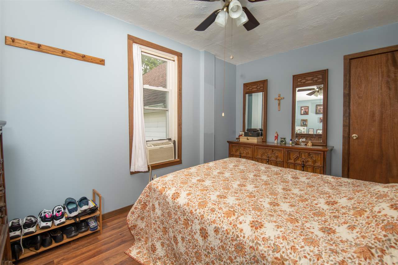 6975 Garden Prairie Road Garden Prairie, IL 61038 - Photo 16 of 28 a bedroom with a bed and a dresser