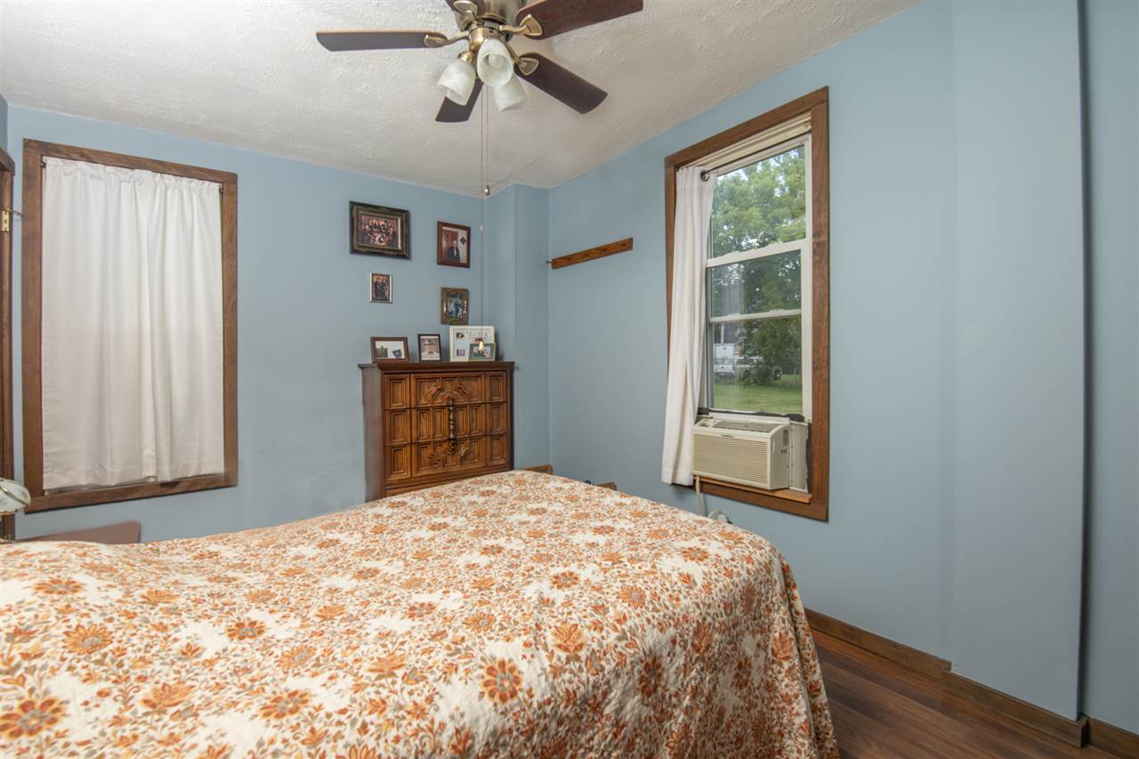 6975 Garden Prairie Road Garden Prairie, IL 61038 - Photo 17 of 28 a bedroom with a bed and a window