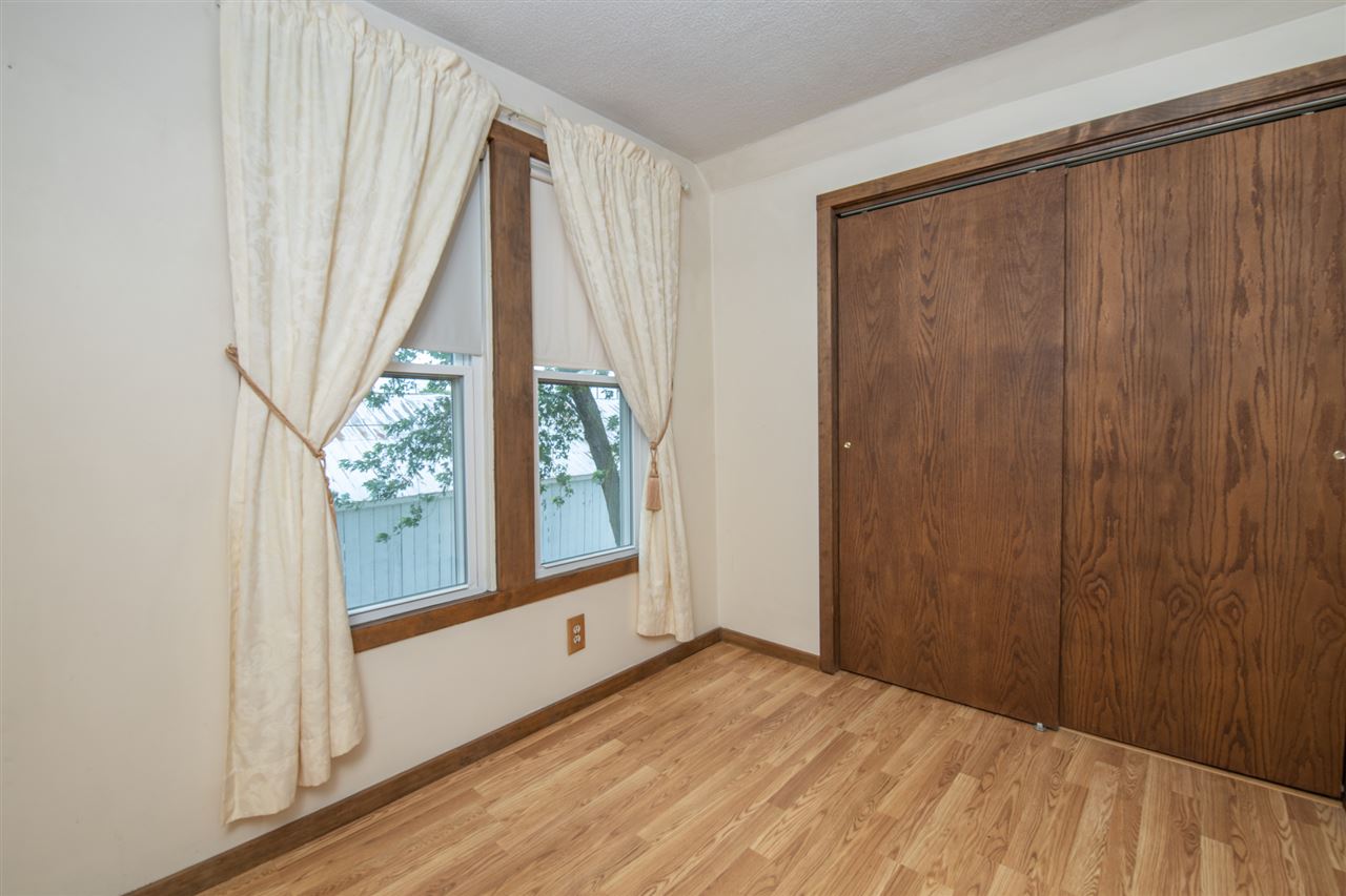 6975 Garden Prairie Road Garden Prairie, IL 61038 - Photo 20 of 28 a view of a room with a large window and wooden floor