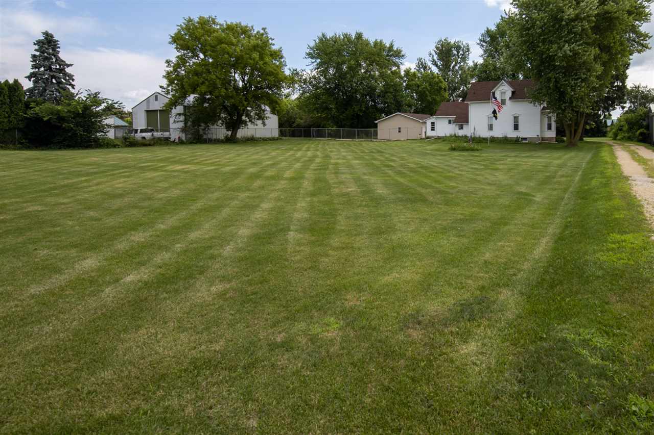 6975 Garden Prairie Road Garden Prairie, IL 61038 - Photo 2 of 28 a front view of a house with a yard and trees