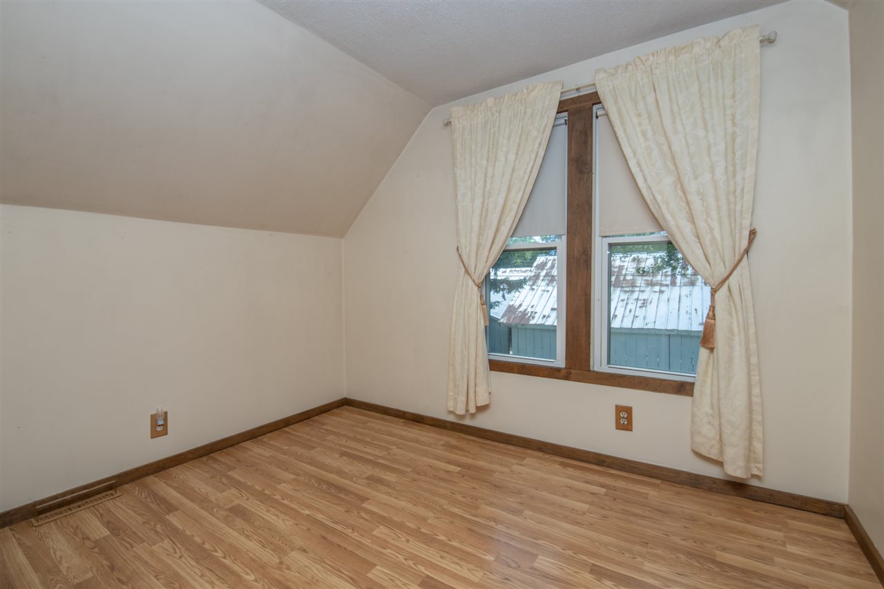 6975 Garden Prairie Road Garden Prairie, IL 61038 - Photo 21 of 28 an empty room with wooden floor and windows