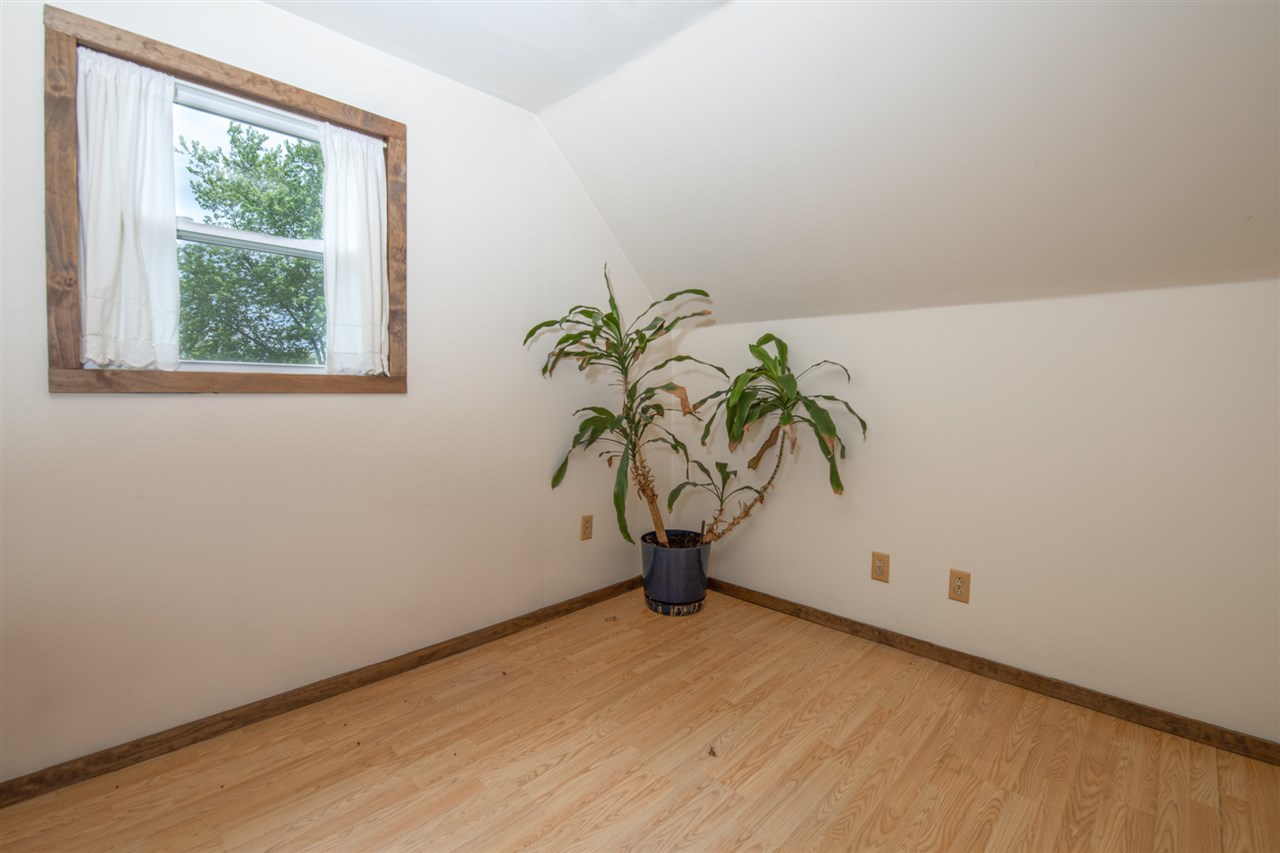 6975 Garden Prairie Road Garden Prairie, IL 61038 - Photo 22 of 28 a view of an empty room with window and a potted plant