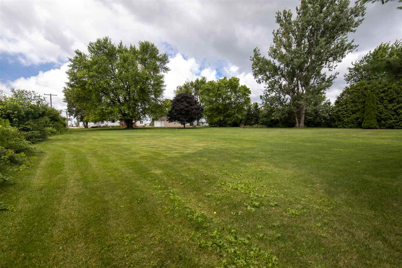 6975 Garden Prairie Road Garden Prairie, IL 61038 - Photo 25 of 28 a view of a field with trees in the background