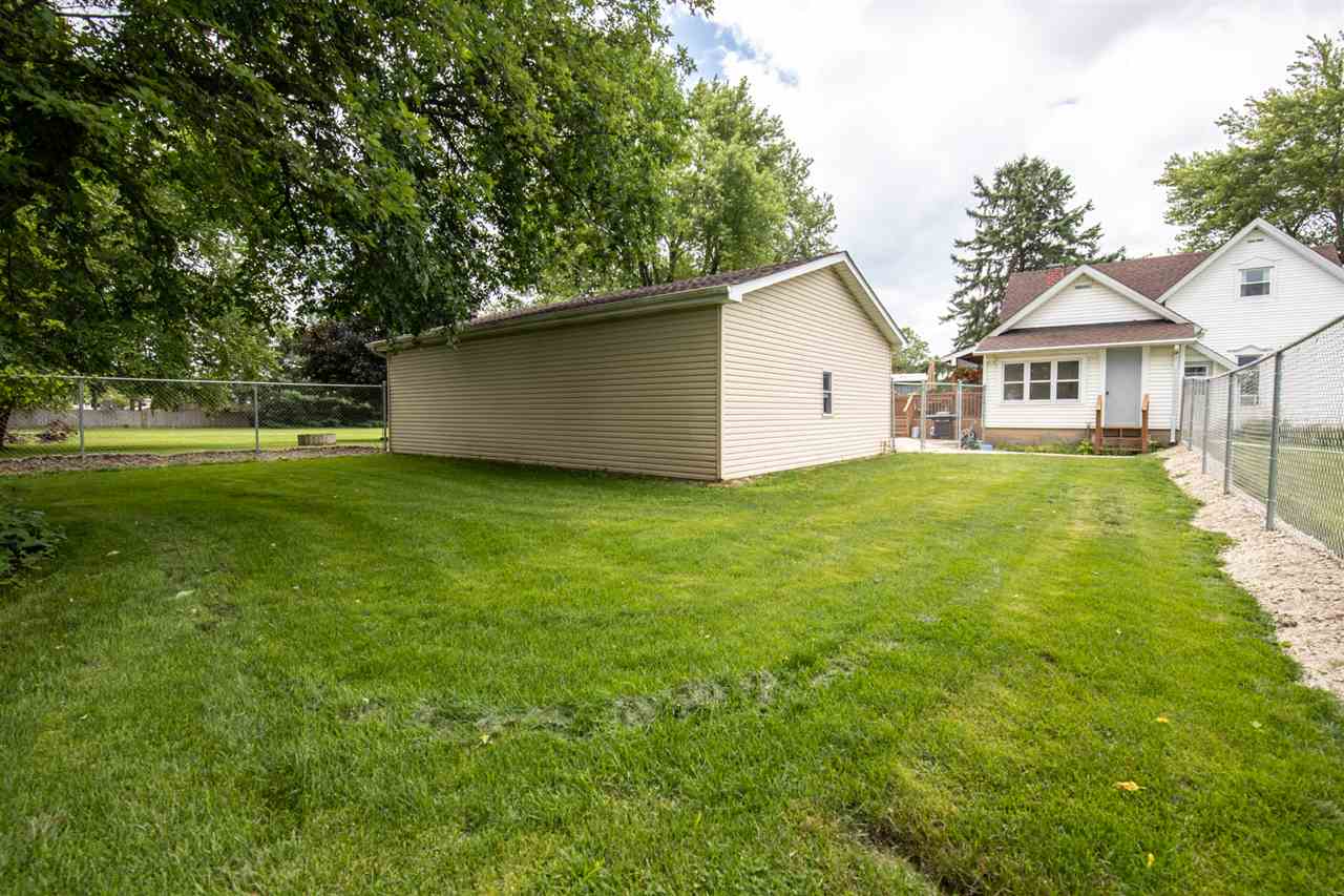 6975 Garden Prairie Road Garden Prairie, IL 61038 - Photo 26 of 28 a view of a house next to a big yard and large trees