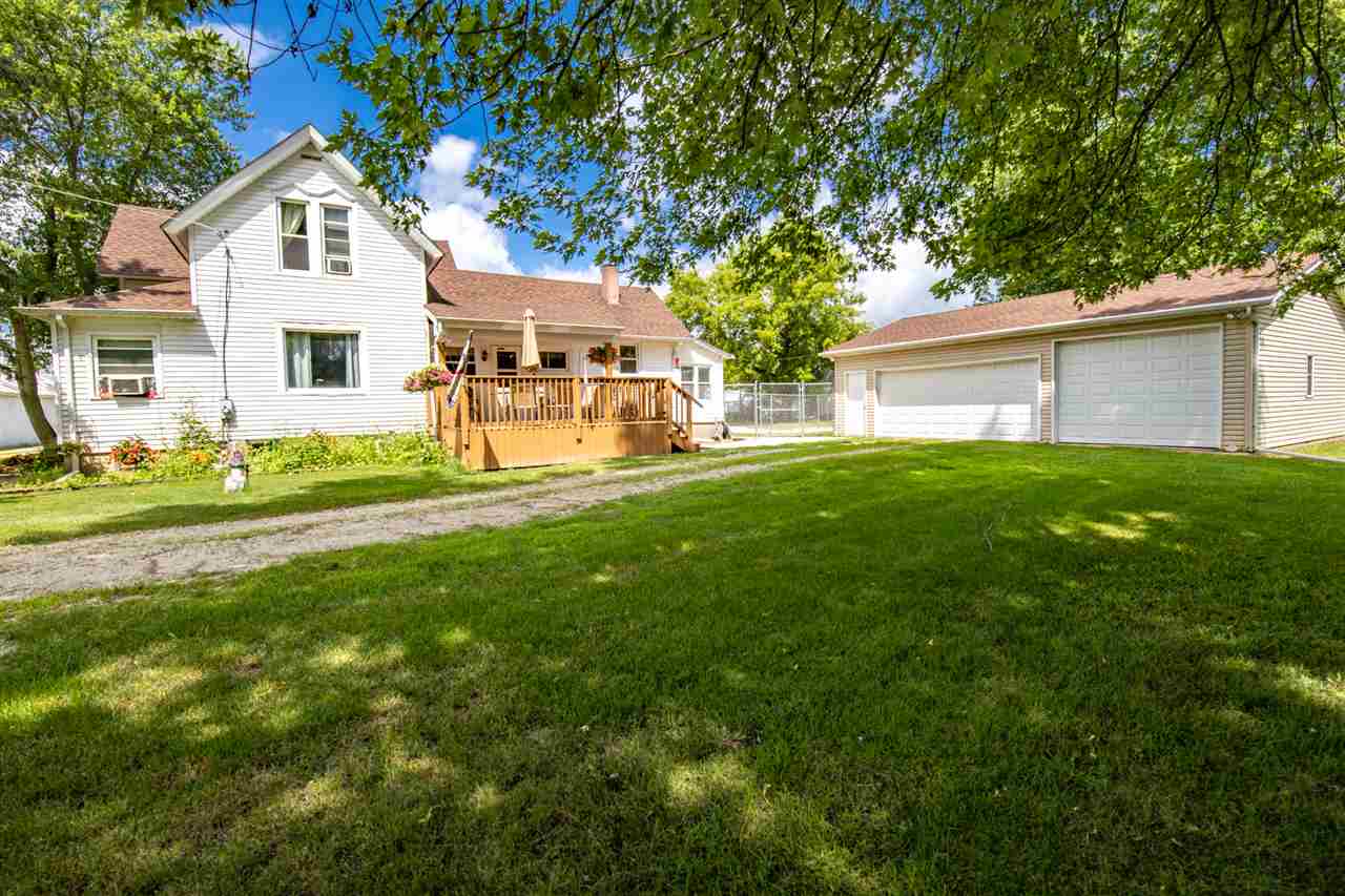 6975 Garden Prairie Road Garden Prairie, IL 61038 - Photo 27 of 28 a house that is sitting in the grass with large trees