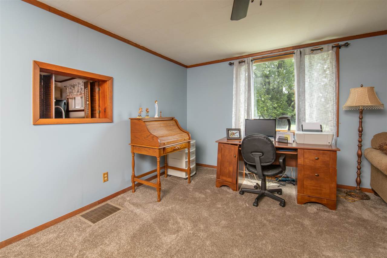 6975 Garden Prairie Road Garden Prairie, IL 61038 - Photo 5 of 28 a view of a workspace with furniture and a window