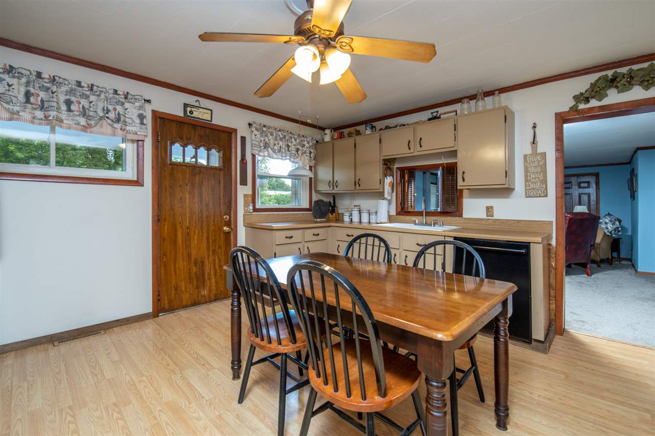 6975 Garden Prairie Road Garden Prairie, IL 61038 - Photo 7 of 28 a view of a a dining room with furniture window and wooden floor