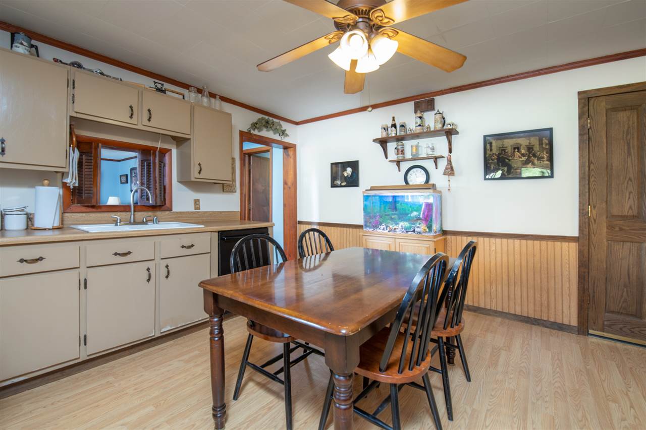6975 Garden Prairie Road Garden Prairie, IL 61038 - Photo 8 of 28 a view of a dining room with furniture and wooden floor