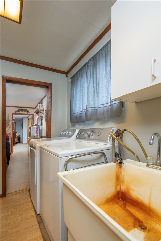 6975 Garden Prairie Road Garden Prairie, IL 61038 - Photo 10 of 28 a kitchen with a sink and a refrigerator