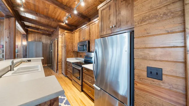 a kitchen with stainless steel appliances a refrigerator and a stove