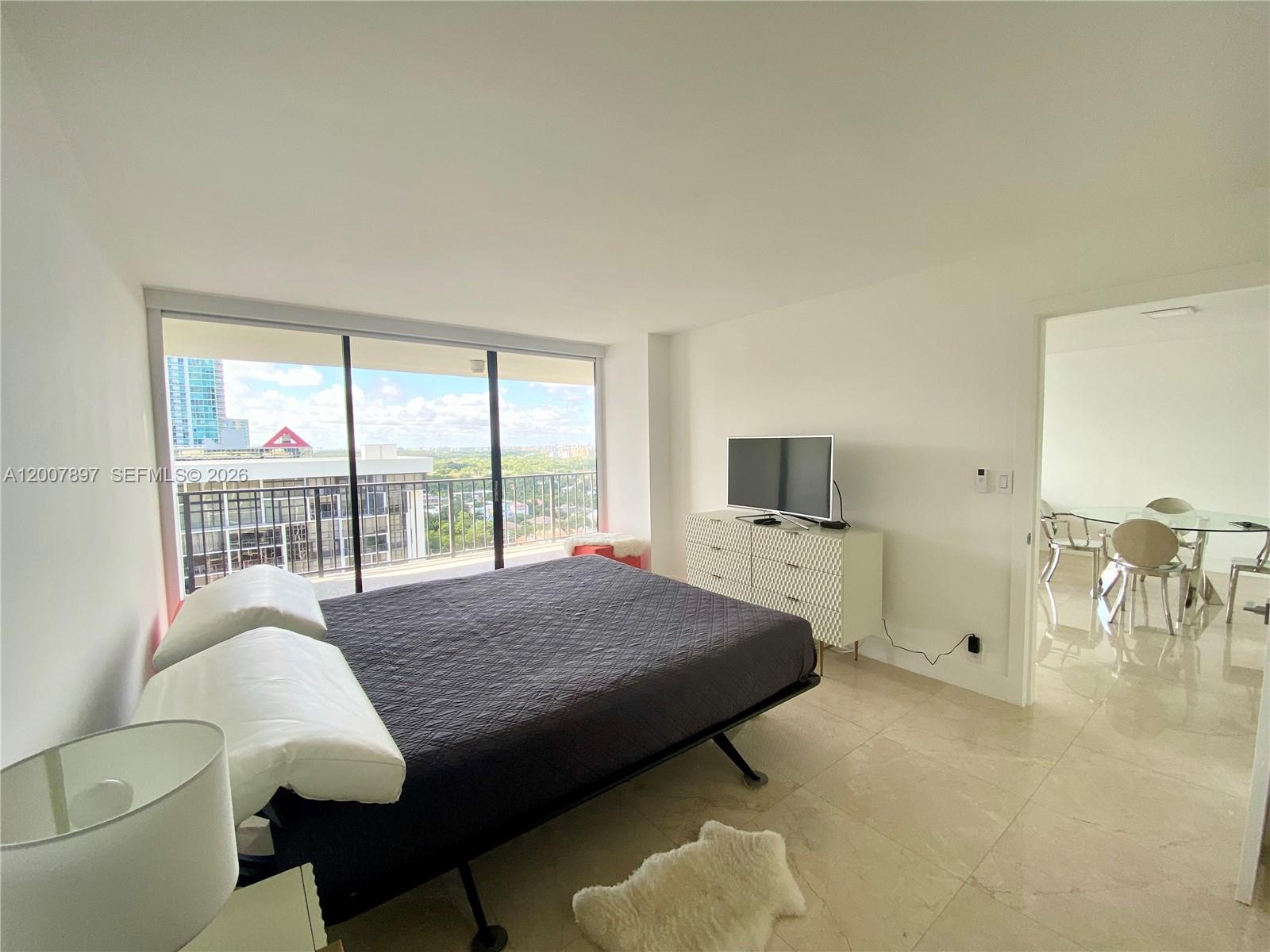 1901 Brickell Avenue, Unit B2007 Miami, FL 33129 - Photo 7 of 11 a living room with furniture and a flat screen tv