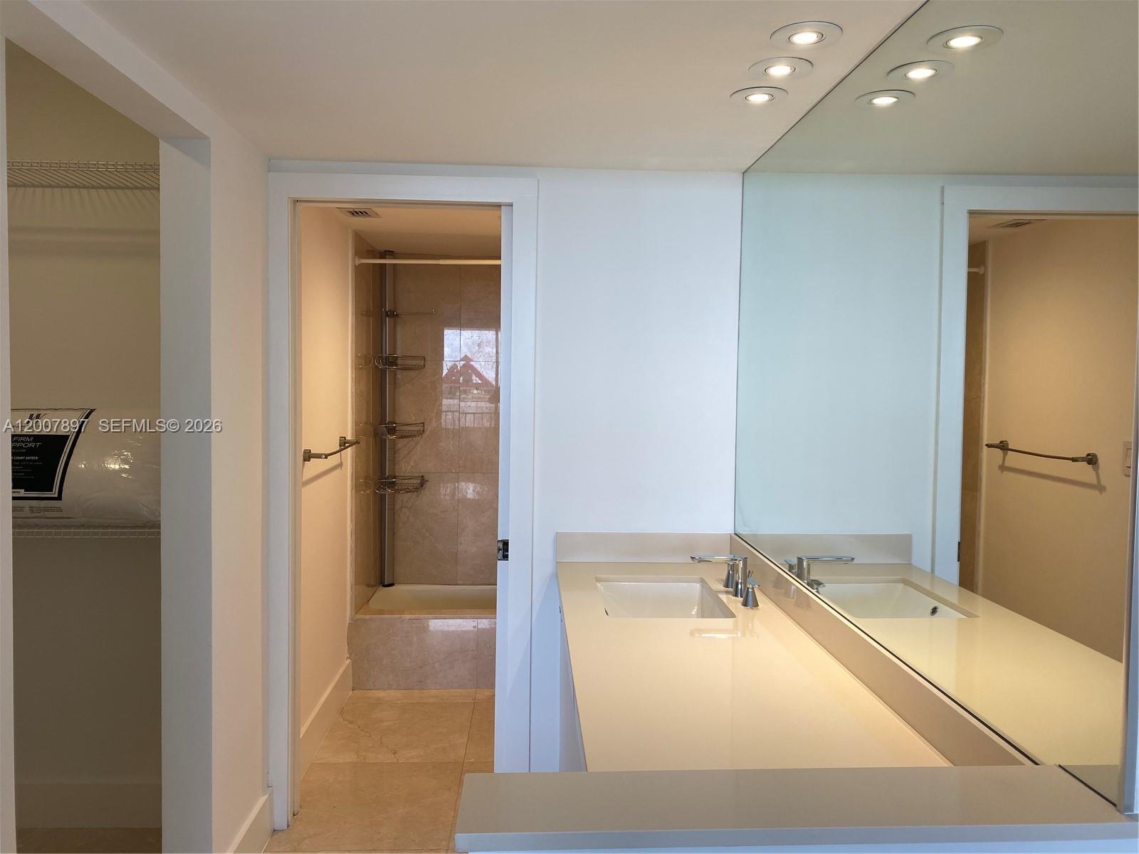 1901 Brickell Avenue, Unit B2007 Miami, FL 33129 - Photo 9 of 11 a bathroom with a tub sink and mirror