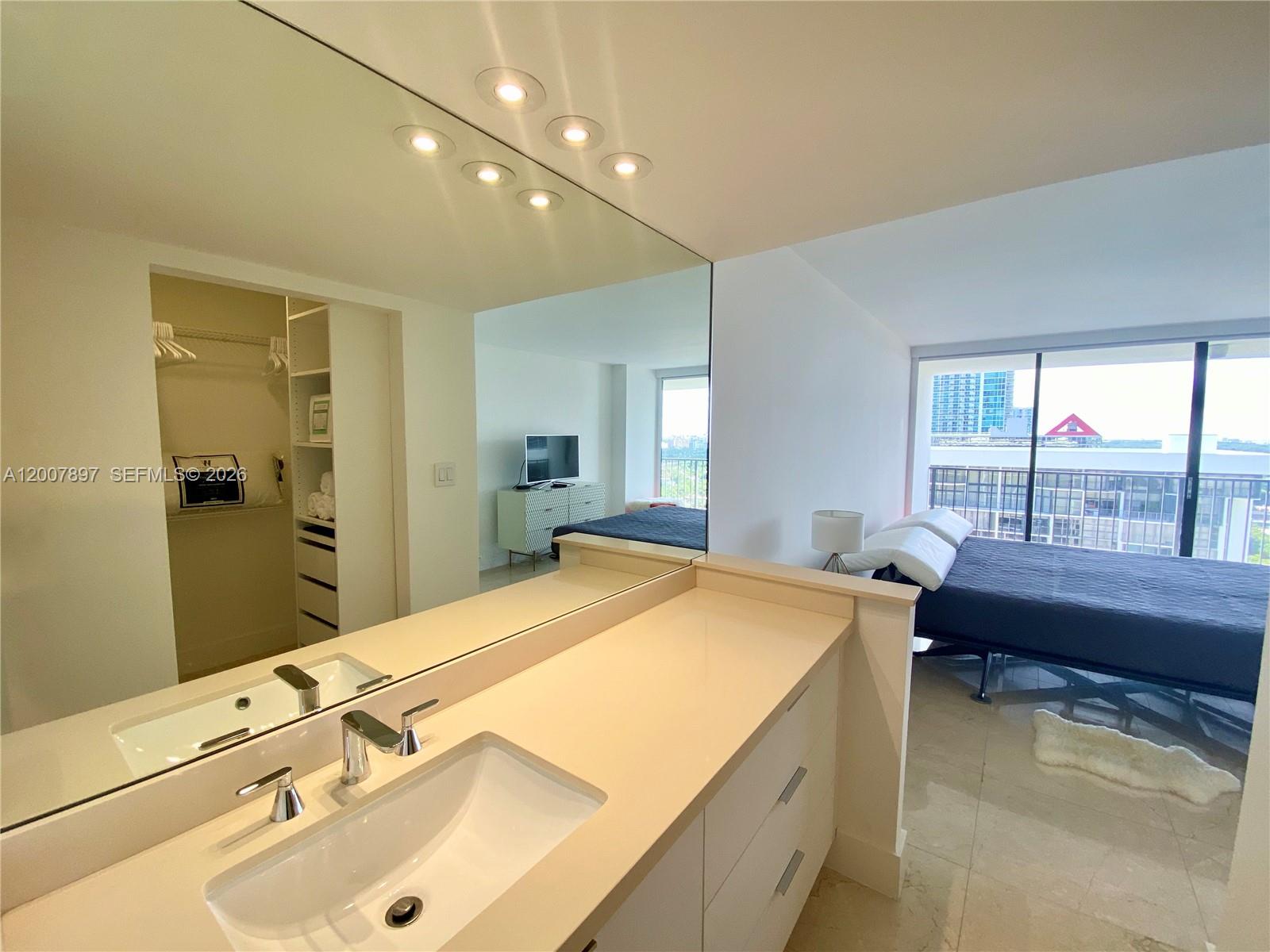 1901 Brickell Avenue, Unit B2007 Miami, FL 33129 - Photo 10 of 11 a bathroom with a tub sink and mirror