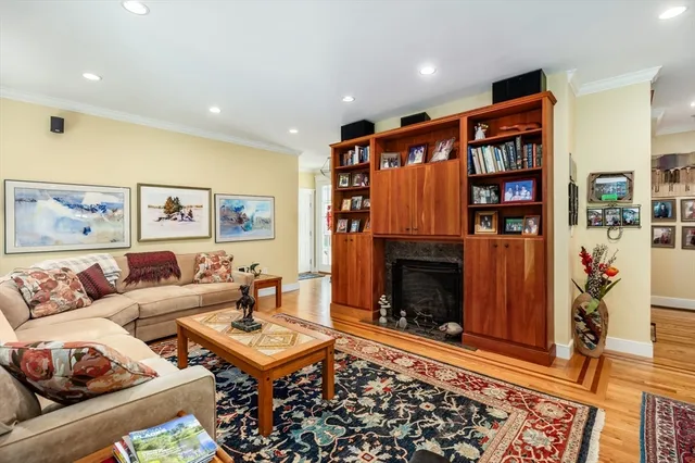 a living room with furniture a rug and a fireplace