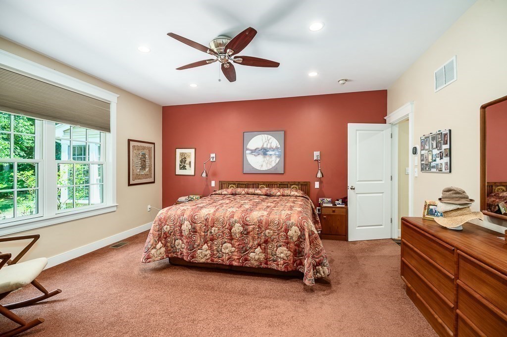 12 Wallis Drive, Unit 12 Wenham, MA 01984 - Photo 14 of 35 a bedroom with a bed and a chandelier