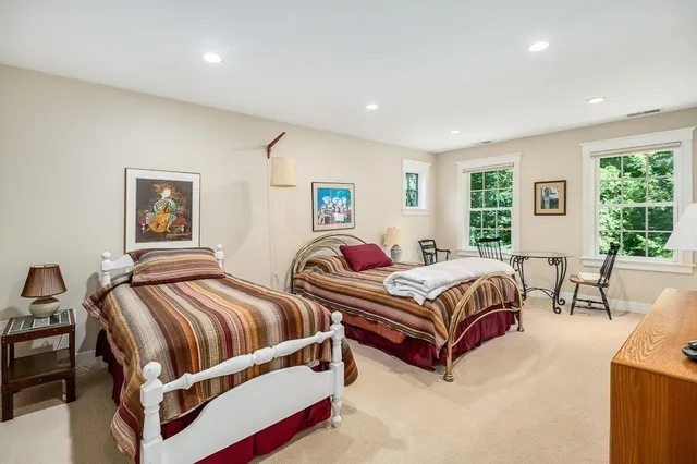 a bedroom with two beds and a large mirror