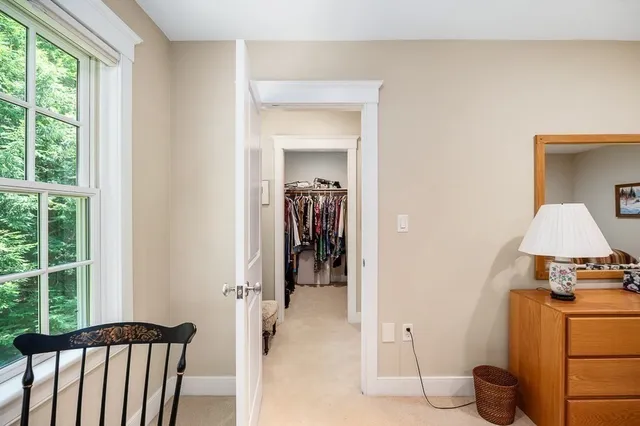 a view of hallway with wooden floor and furniture