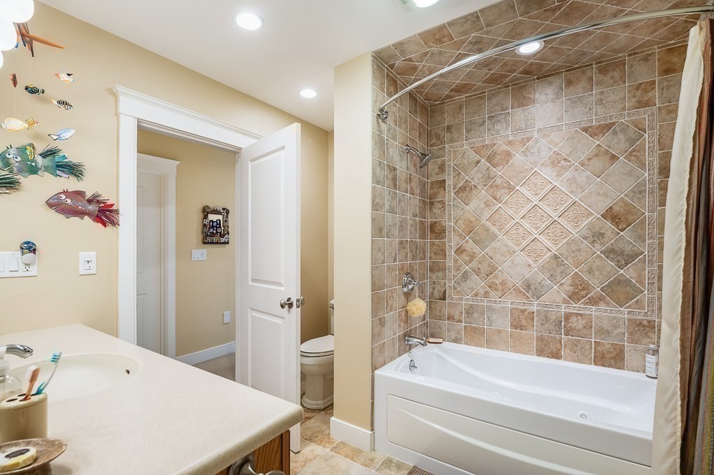 12 Wallis Drive, Unit 12 Wenham, MA 01984 - Photo 20 of 35 a bath room with a bath tub and a shower