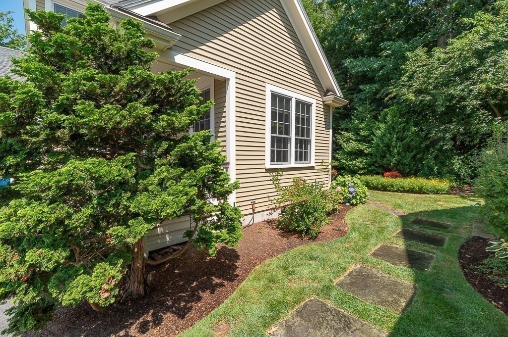 12 Wallis Drive, Unit 12 Wenham, MA 01984 - Photo 23 of 35 a backyard of a house with outdoor seating and plants