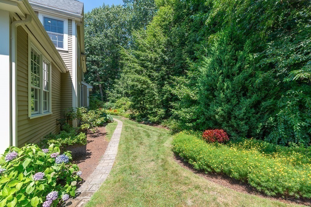 12 Wallis Drive, Unit 12 Wenham, MA 01984 - Photo 25 of 35 a backyard of a house with a yard and outdoor seating