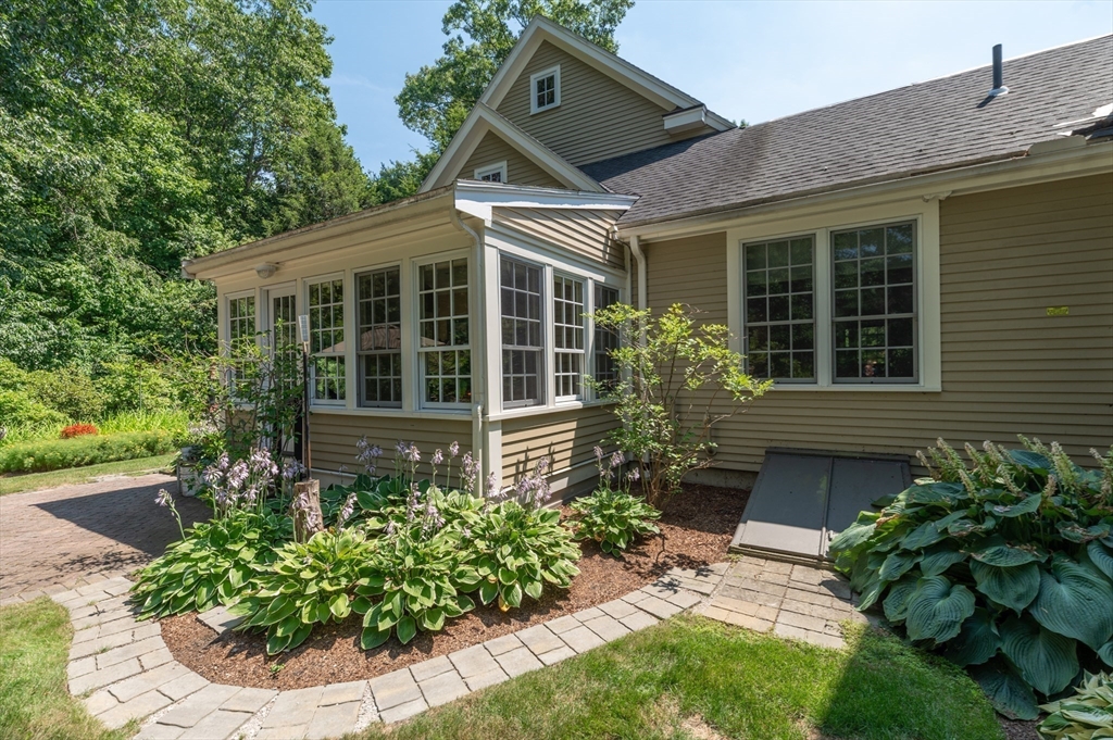 12 Wallis Drive, Unit 12 Wenham, MA 01984 - Photo 30 of 35 a front view of a house with a yard